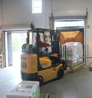 forklift with a pallet of rta cabinets