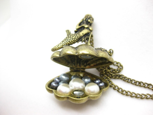 http://imagehost.vendio.com/preview/a/35111061/aview/mermaid_2520brass_2520open_2520locket.jpg