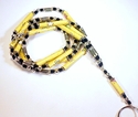 Yellow Paper Beads With Stars Silver Tone Badge / 