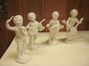 Set of Four Bisque Cherub Figurines with Instrumen