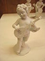 Set of Four Bisque Cherub Figurines with Instrumen