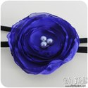 Vincha elástica con flor en gasa violeta