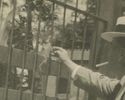 Rppc Man With Hat Smoking Cigarette Feeds Bit Of H